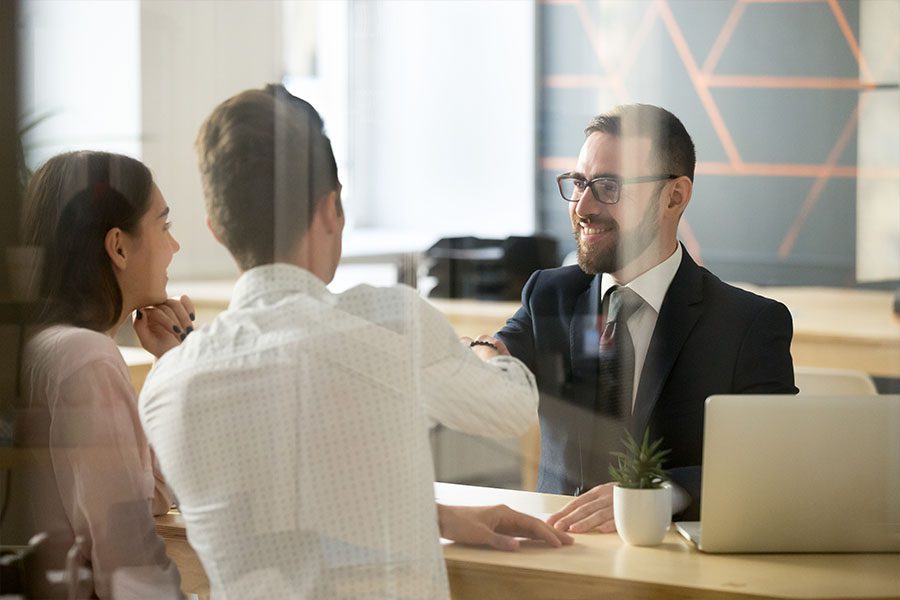 Financial Institution Insurance - Banker Meeting with a Prospecting Housing Couple Interested in a Loan